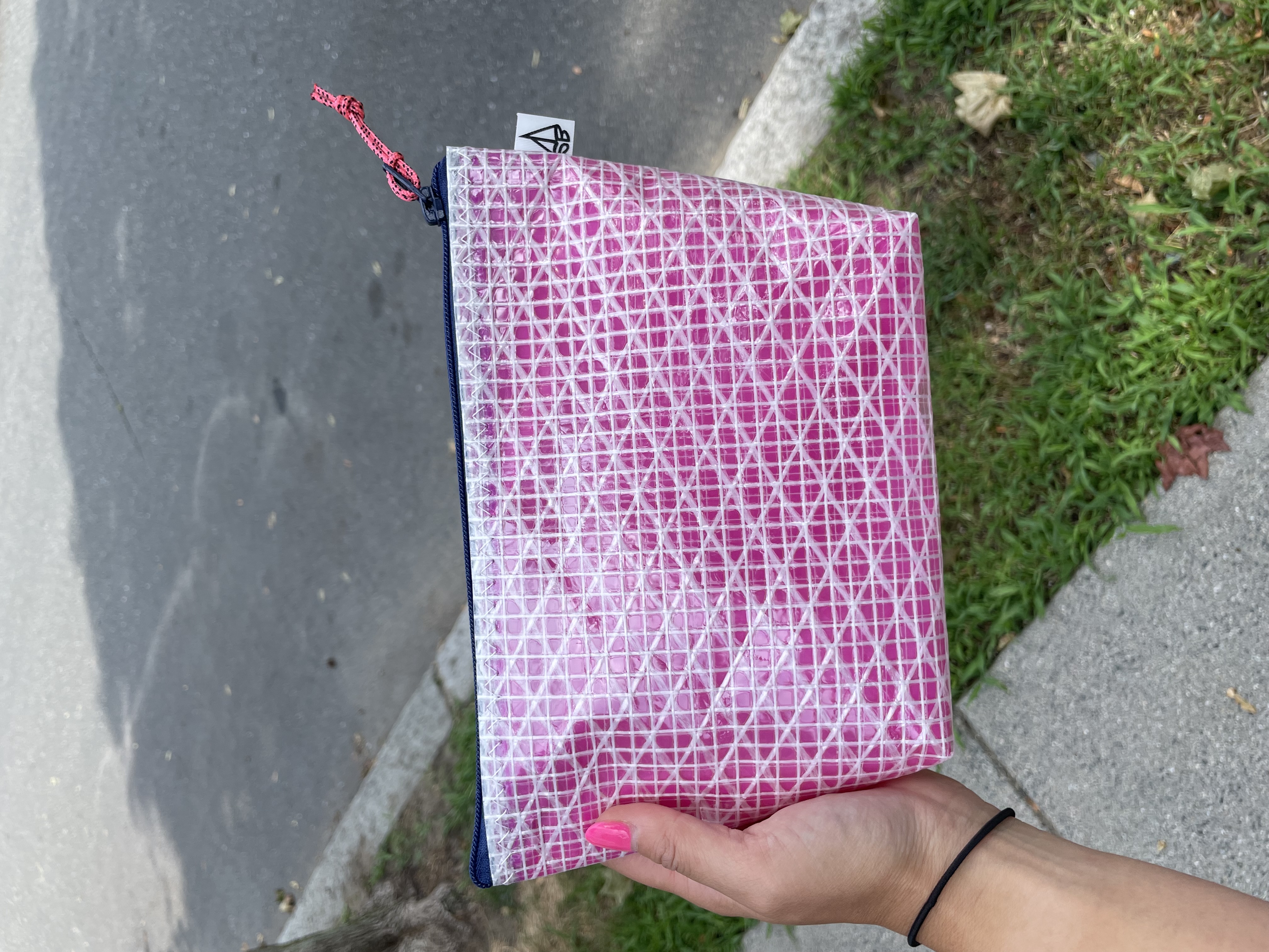 Pink scrim pouch in hand