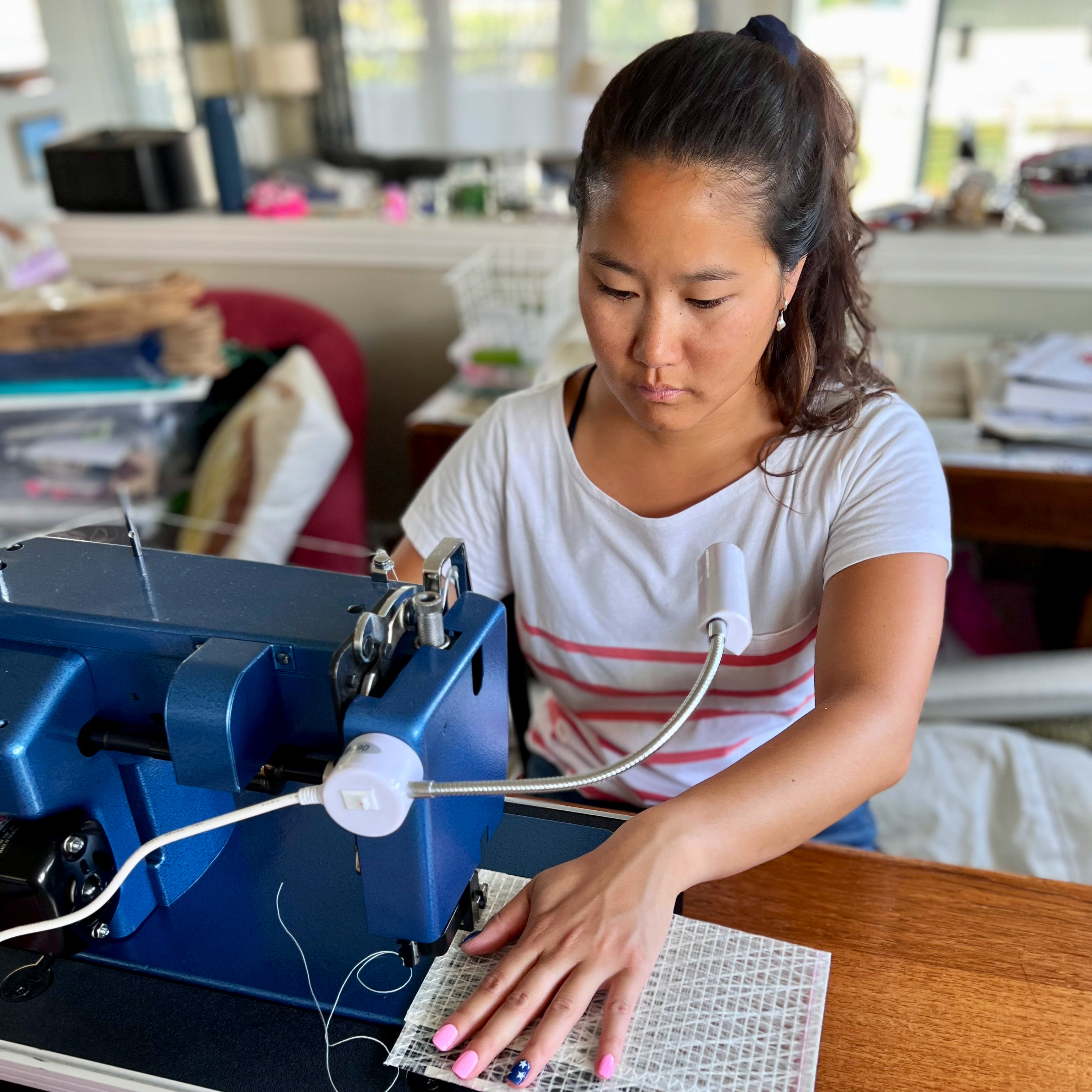 Laura sewing sailcloth at the machine